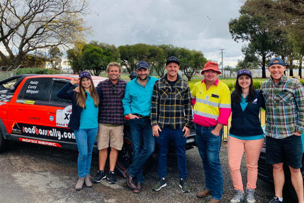 Lifeguards from Bondi Rescue smiling for a photo with GIVIT staff and Jamie Lawson from Road Boss Rally