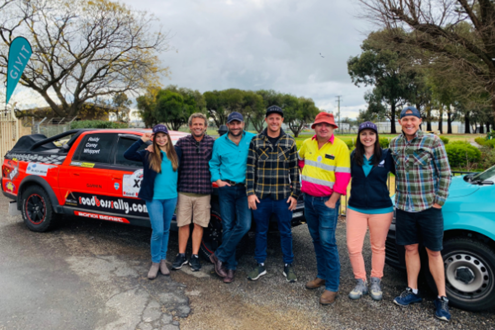 Lifeguards from Bondi Rescue smiling for a photo with GIVIT staff and Jamie Lawson from Road Boss Rally